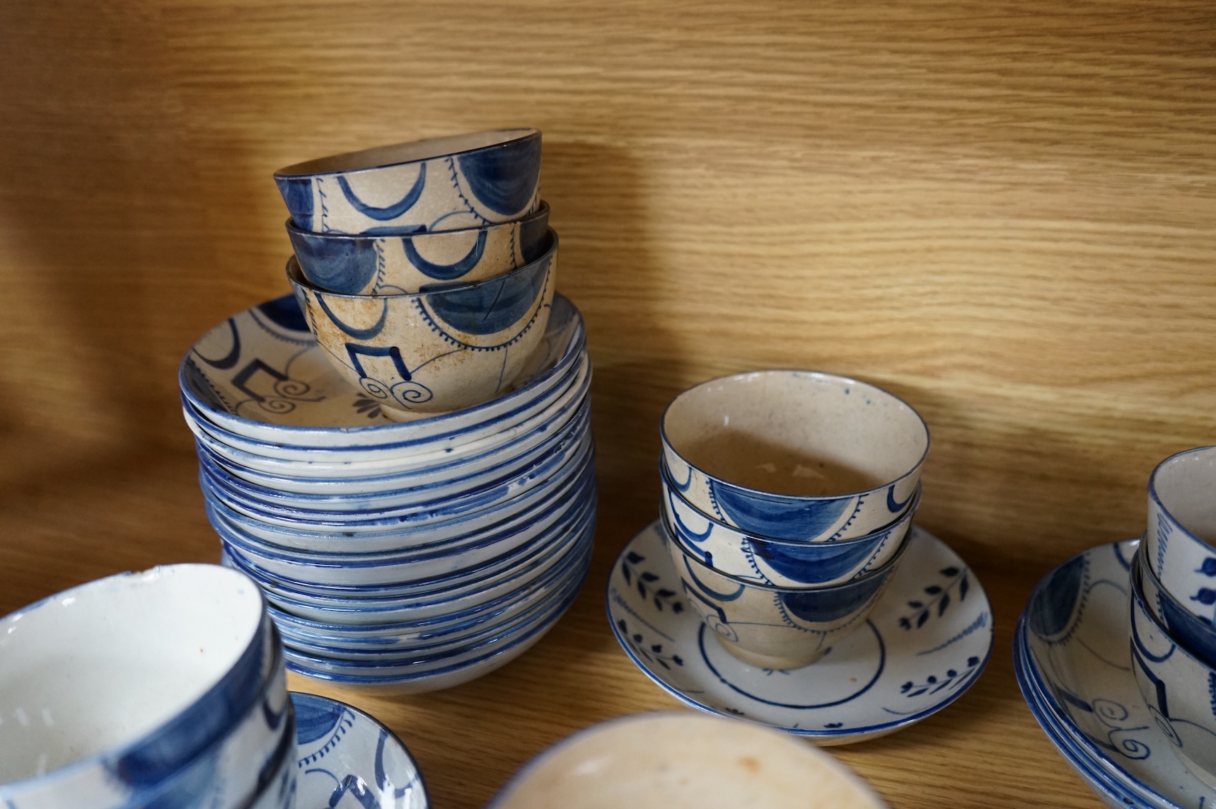 A group of 19th century pearlware set of tea bowls and saucers and to similar basket with border plates